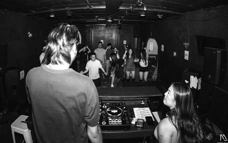 The room from behind the decks, floor filling up